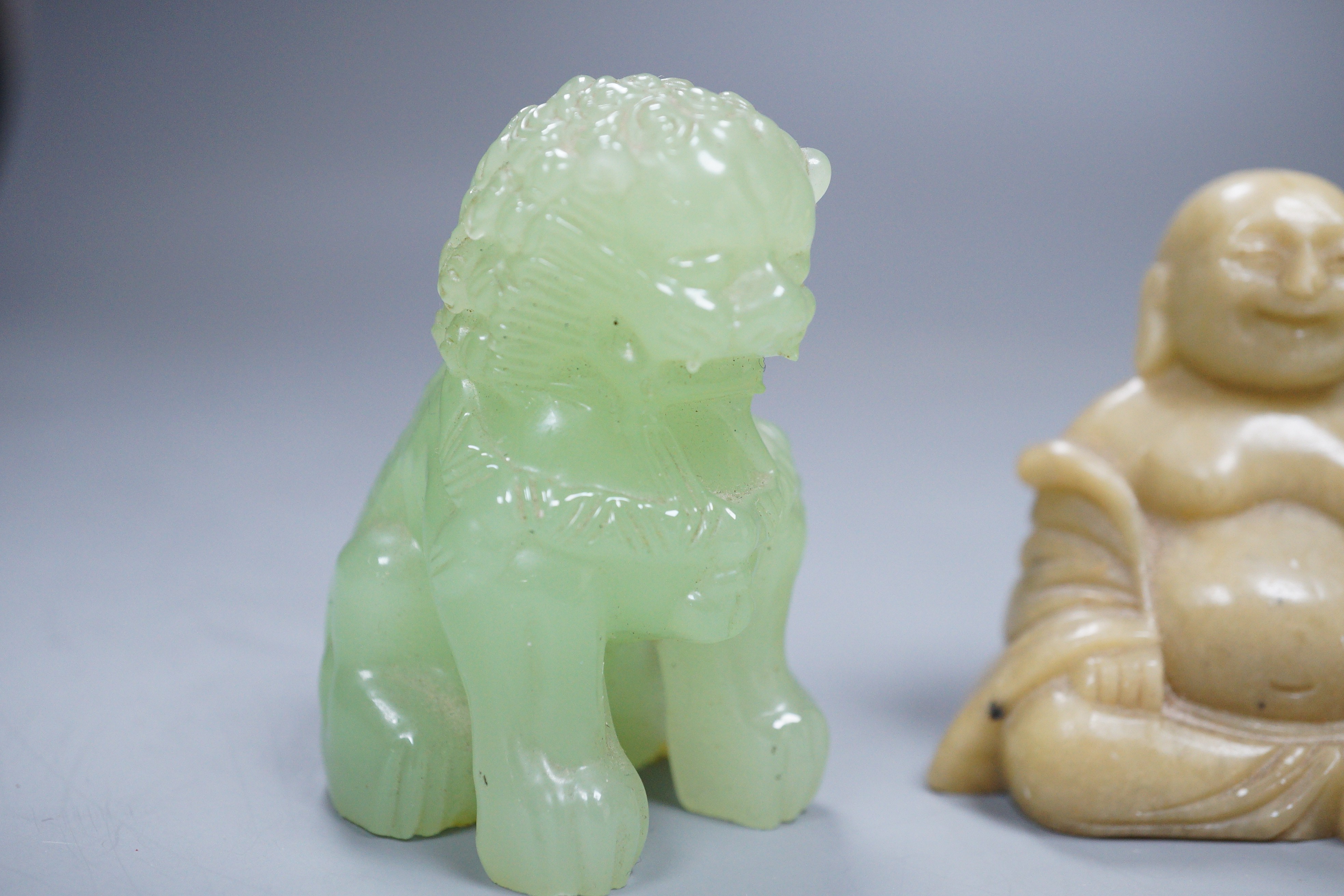 Two bowenite Buddhistic lions and a soapstone Buddha, 7cm